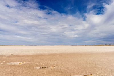 Scenic view of salt lake against sky