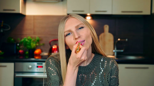 Portrait of young woman with chocolate at home