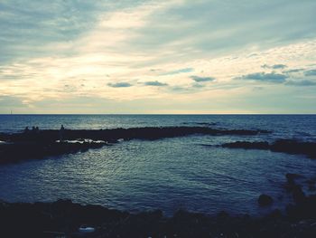 View of calm sea against scenic sky