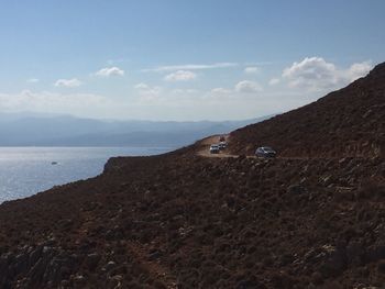 Car on shore against sky