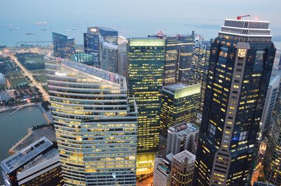 High angle view of buildings and sea against sky