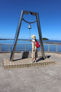 Woman standing on promenade against sky