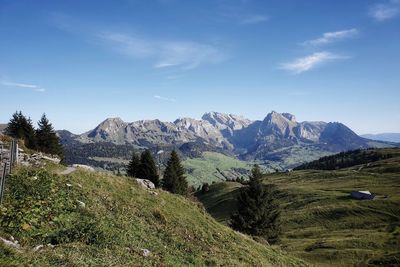 Scenic view of landscape against sky and mountains 