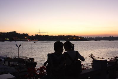 Silhouette of people looking at sunset