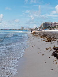 Scenic view of beach against sky in city