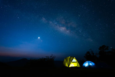 Milky way with meteor star and hiking tent in summer time
