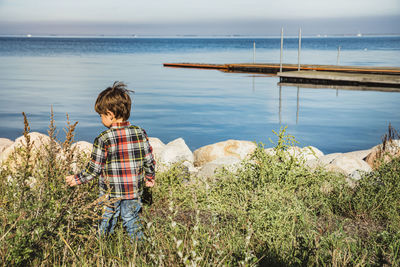 Rear view of boy looking at sea