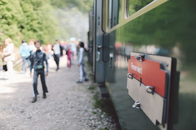 Information sign on train by people walking on field