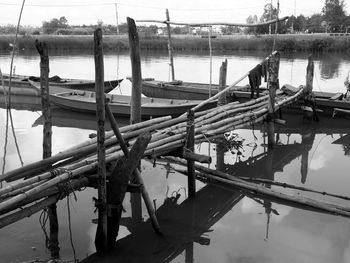 Boats moored in lake against sky