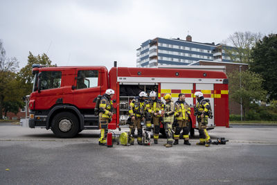 Firefighters team in front of fire engine
