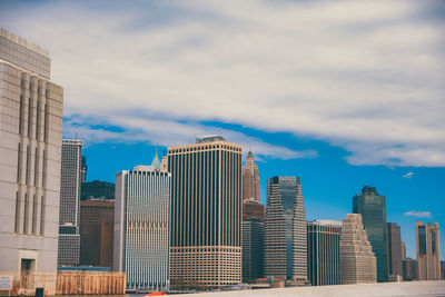 City skyline against cloudy sky