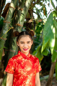 Portrait of a smiling young woman standing outdoors