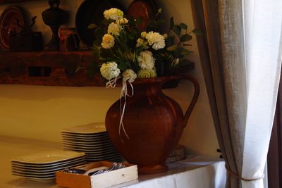 Close-up of flower vase on table at home
