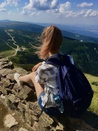 Rear view of woman standing on mountain