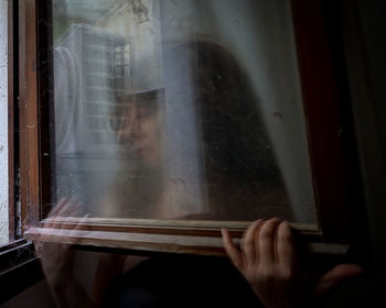 Reflection of person hand on glass window