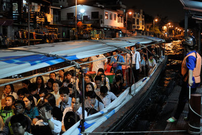 People in boat on canal at night