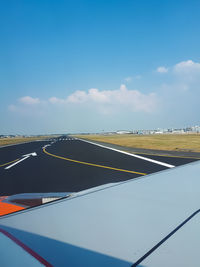 Airplane on road against sky