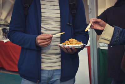 Midsection of man holding ice cream