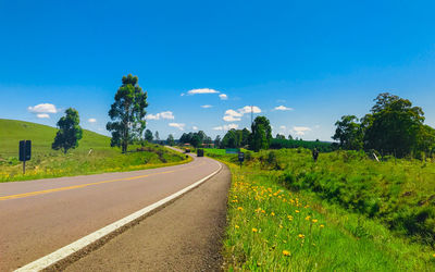 Empty road along countryside landscape