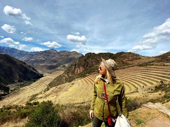 Full length of man standing on mountain against sky