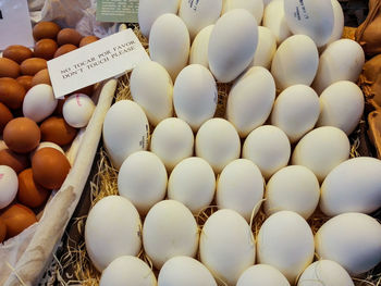 High angle view of brown and white eggs for sale on market stall