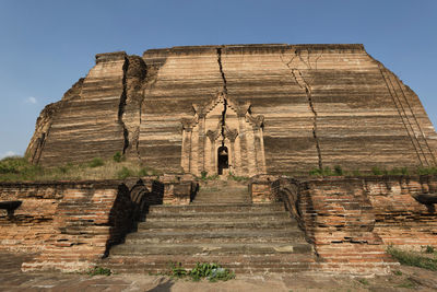 Low angle view of old ruin against sky