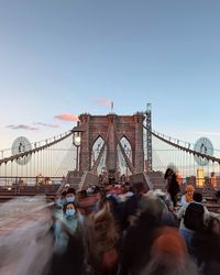 Rear view of people walking on bridge