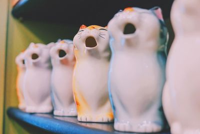 Cat figurines on shelf for sale at shop