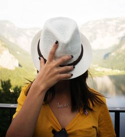 Close-up of young woman wearing hat