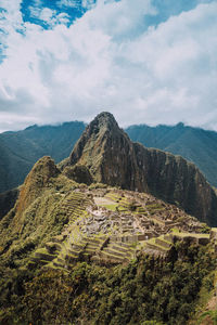 Scenic view of mountains against cloudy sky