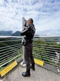 Low angle view of man standing on bridge