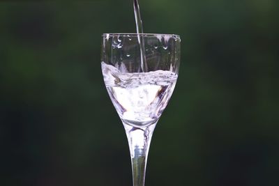 Close-up of water glass against black background