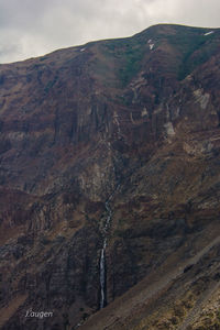 View of landscape with mountain range in background