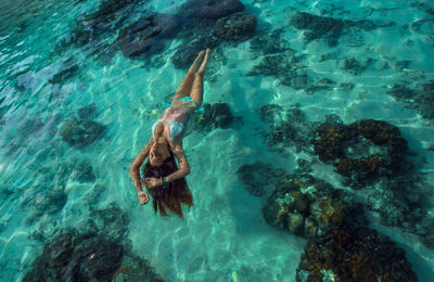 High angle view of woman swimming in sea