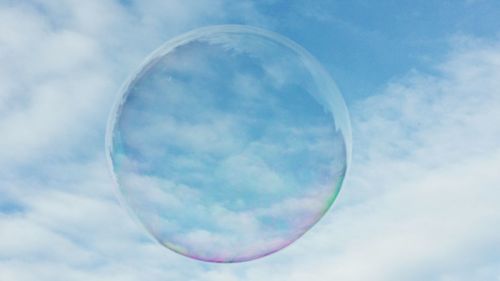 Low angle view of bubbles against sky