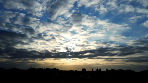 Silhouette cityscape against sky during sunset