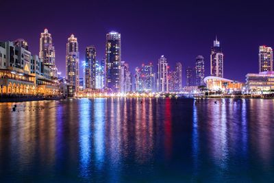 Illuminated city at waterfront