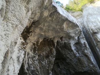 Low angle view of rock formation in water