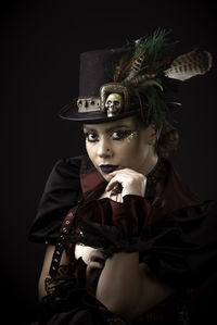 Woman in costume against black background