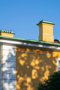 Low angle view of building against clear blue sky