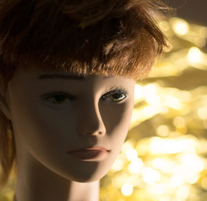 Close-up of doll against illuminate lighting equipment