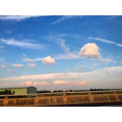 Scenic view of river against cloudy sky