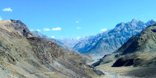 Scenic view of snowcapped mountains against blue sky