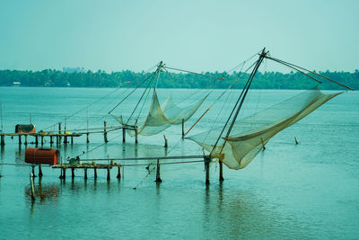 Fishing net in sea against clear sky