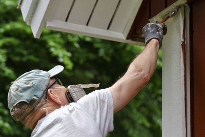 A man painting the house