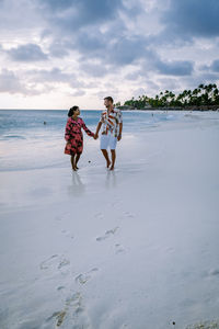 Rear view of women walking on beach