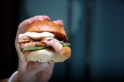 Close-up of hand holding burger