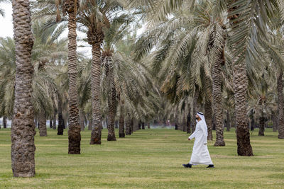 Rear view of women standing on field