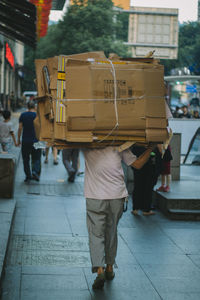 Rear view of man working in shopping cart