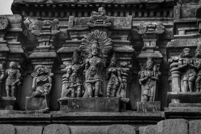 Low angle view of statue against temple